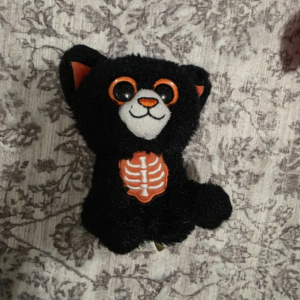 Black Plush Cat with Orange Skeleton Design